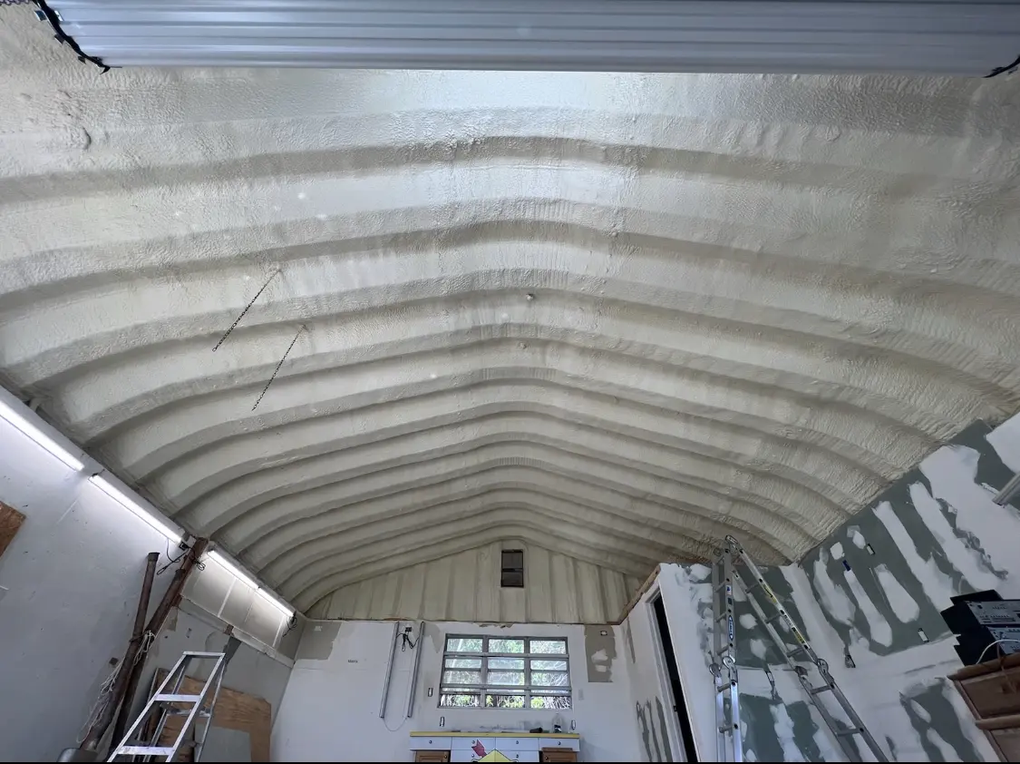 Spray polyurethane foam applied to the underside of a metal roof deck in Kearny